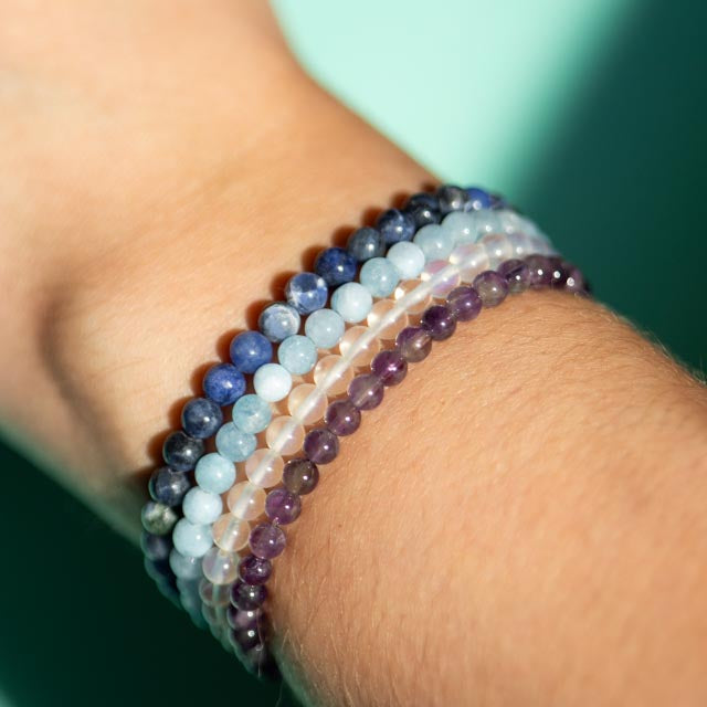Four Crystals sodalite, amethyst, clear quartz, and aquamarine beaded bracelets 